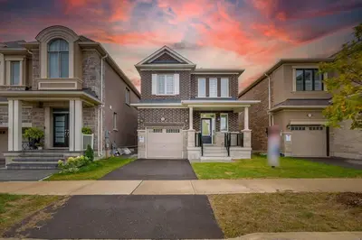 a large brick house with two garage at 922 Logan Drive in Milton