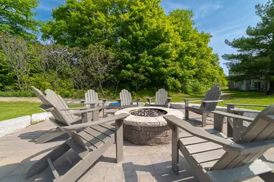 a group of chairs sitting around a fire pit at Horseshoe Valley Suites - The Aurora in Shanty Bay
