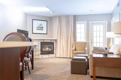 a living room with a fireplace and a couch at Horseshoe Valley Suites - The Aurora in Shanty Bay