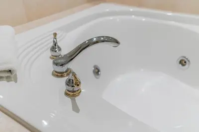 a white bath tub with a silver faucet at Cozy Getaway with Resort Perks in Edgar
