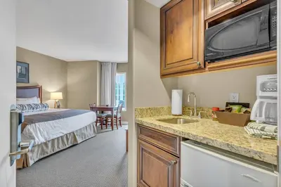 a hotel room with a bed and a kitchen with a sink at Cozy Getaway with Resort Perks in Edgar