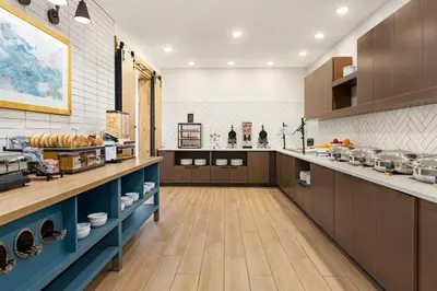 a large kitchen with wooden cabinets and a counter top at Staybridge Suites Port Elgin by IHG in Port Elgin