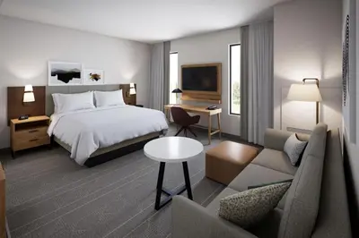 a hotel room with a bed and a couch at Staybridge Suites Port Elgin by IHG in Port Elgin