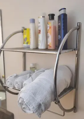 a towel rack with rolls of toilet paper on it at Beautiful House in Mississauga in Mississauga