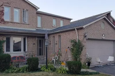 a brown brick house with a garage at Beautiful House in Mississauga in Mississauga