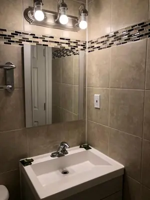 a bathroom with a sink and a mirror at Mayflower Motel in Kitchener