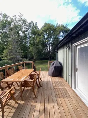 a wooden deck with a wooden table and chairs at Downtown Picton 3 bedroom in Picton
