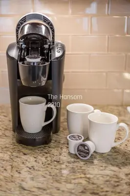 a coffee maker with three cups on a counter at Country Club Charm - 4-Bed Radiant Resort Condo in Edgar
