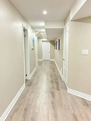 a hallway with white walls and wood flooring at Cozy 1.5 Guest-Suite in Aurora