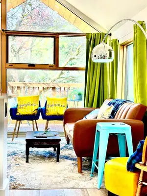 a living room with a couch and two chairs at Tiny House Haven in Peterborough