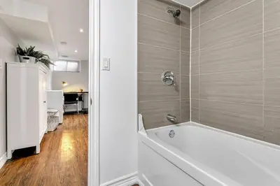 a bathroom with a bath tub in a room at Lakeside Retreat near Toronto in Mississauga