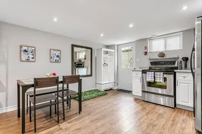 a kitchen with a table and a stove top oven at Lakeside Retreat near Toronto in Mississauga