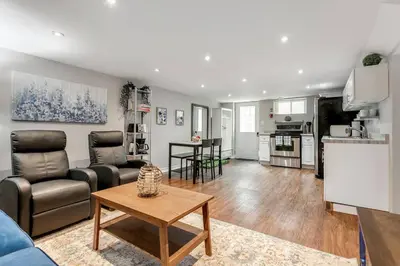 a living room with a couch and a table at Lakeside Retreat near Toronto in Mississauga