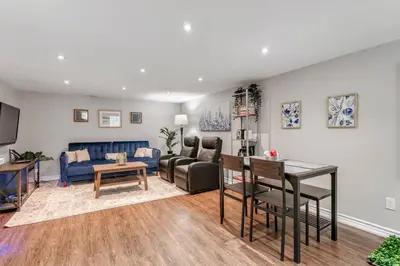 a living room with a couch and a table at Lakeside Retreat near Toronto in Mississauga