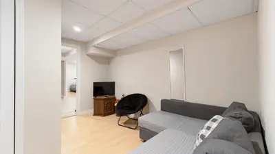 a living room with a couch and a tv at Finished 2 BR Apartment in an Upscale Area of Ajax in Ajax