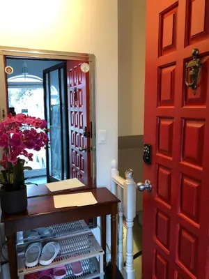 a red door with a table and a mirror at Angelina’s house in Toronto