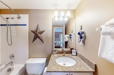 a bathroom with a sink and a toilet and a tub at Condo 708 at North Creek Resort in Blue Mountains