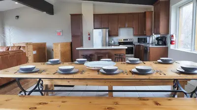 a kitchen with a wooden table with bowls on it at Gateside Chalets Expansive 6 Bedroom Hot Tub Near Village Blue Mountain in Blue Mountains