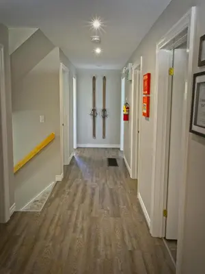 a hallway of a home with wood floors at Gateside Chalets Expansive 6 Bedroom Hot Tub Near Village Blue Mountain in Blue Mountains