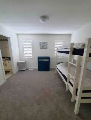 a bedroom with two bunk beds in a room at Modern & Cozy Kawartha Getaway in Kawartha Lakes