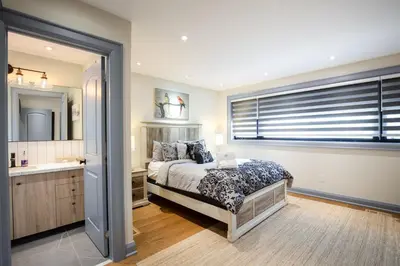 a bedroom with a bed and a sink and a window at N7 Castle Green Retreat-Hot Tub in Toronto