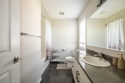 a bathroom with a sink and a toilet and a mirror at GlobalStay 3 Bedroom House with Parking Brampton in Brampton