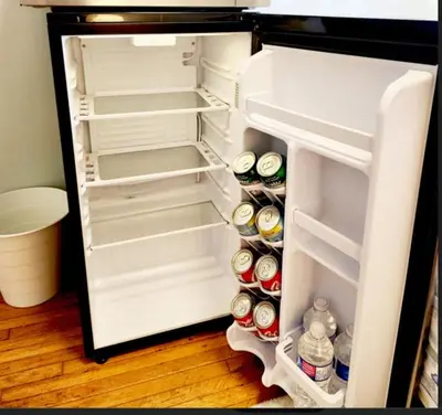 an open refrigerator filled with lots of drinks and food at Toronto Uptown 1 - Bus to Downtown in Toronto