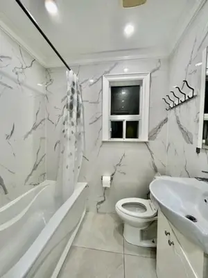 a white bathroom with a toilet and a sink at Toronto Uptown 1 - Bus to Downtown in Toronto
