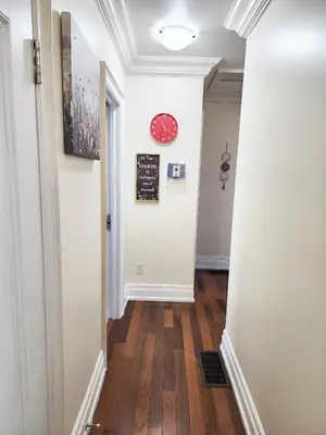 a hallway with a clock on the wall at Toronto Uptown 3 - Bus to Downtown in Toronto