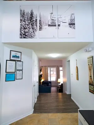 two views of a living room with a house at Modern Townhome at Wintergreen Sauna Steps from Blue Mountain Village in Blue Mountains