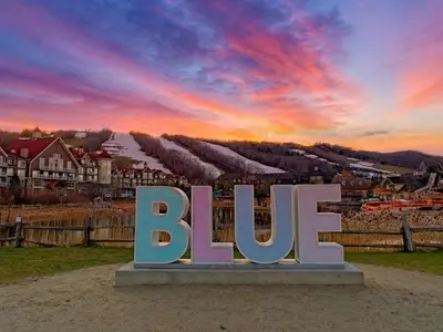 a large sign that says bue in front of a city at Modern Townhome at Wintergreen Sauna Steps from Blue Mountain Village in Blue Mountains