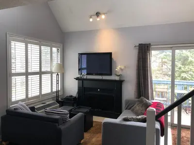 a living room with a flat screen tv and a fireplace at Blue Mountain Escape, WIFI, Base of North lift in Blue Mountains