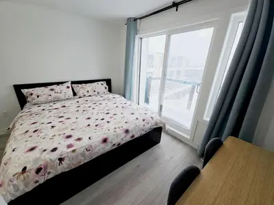 a bedroom with a bed and a large window at King Bed TV Private Ensuite Retreat Bathroom or Economical Double Bed Room in Toronto