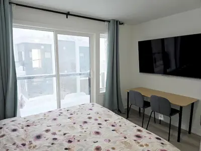 a bedroom with a bed and a table and a window at King Bed TV Private Ensuite Retreat Bathroom or Economical Double Bed Room in Toronto