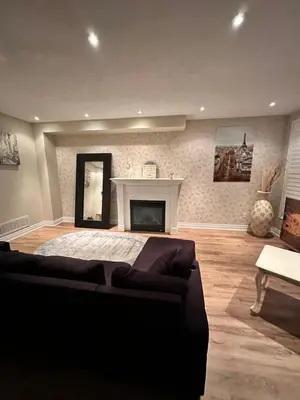 a living room with a bed and a fireplace at Beautiful Master bedroom unit with private washroom in Mississauga