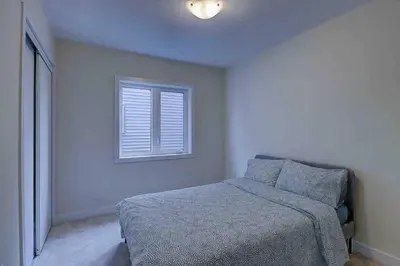a bedroom with a bed and a window at Modern NEW Build in Caledonia in Caledonia