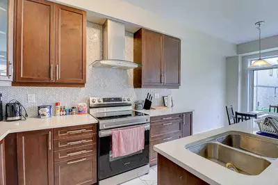 a kitchen with a sink and a stove top oven at Modern NEW Build in Caledonia in Caledonia