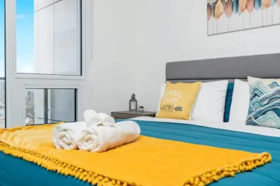 a bedroom with a bed with a towel animal on it at Luxury 1BR King Bed Unit - Private Balcony in Kitchener