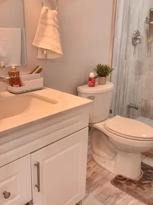 a bathroom with a toilet and a sink and a shower at SUITE A 2 Bedroom Apartment in Brampton