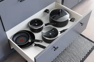 a cabinet with four pots and pans in it at Comfortable Lux, Sleeps 10, PingPong, Movie Room in London