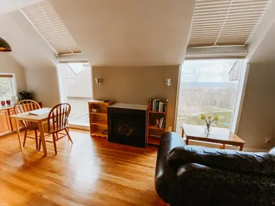 a living room with a couch and a table at Irish Mountain Suites in Meaford