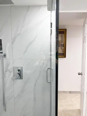 a shower with a glass door in a bathroom at Tidy Private Rooms with Full Kitchen in Toronto