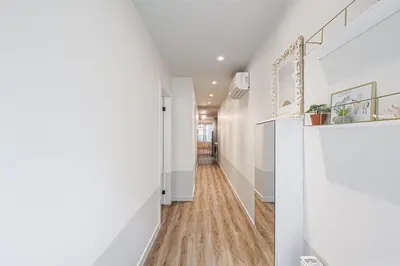 a hallway with white walls and wood floors at Downtown Oasis-2BR-Spa Bath-Pet Friendly, Free Parking in Toronto