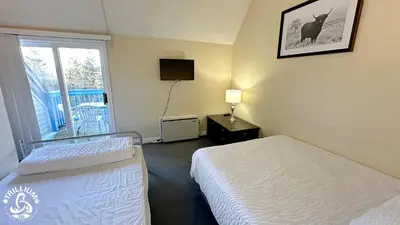 a hotel room with two beds and a window at Mountainview Loft at North Creek Resort in Blue Mountains