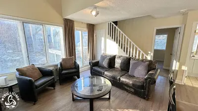 a living room with a couch and chairs and a table at Mountainview Loft at North Creek Resort in Blue Mountains