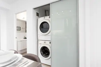 a laundry room with a washer and dryer at The Vine & View Suite in Toronto