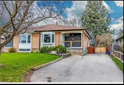 a house with a driveway in front of it at Cozy room near Pickering OPG in Pickering