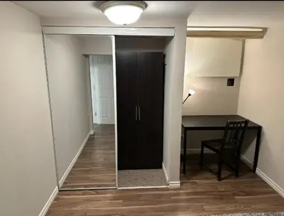 a hallway with a door and a desk in a room at Cozy room near Pickering OPG in Pickering