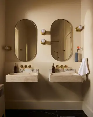 two sinks in a bathroom with two mirrors at Hotel Julie in Stratford