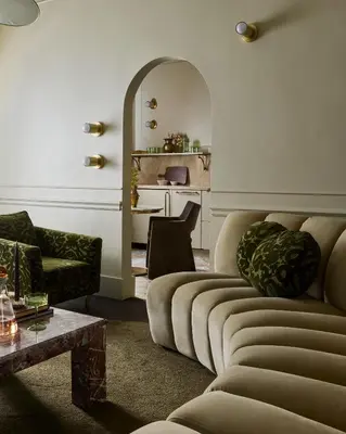 a living room with two couches and a table at Hotel Julie in Stratford